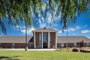 Exterior of Sand Sage of the Highlands senior living community in Mustang, OK